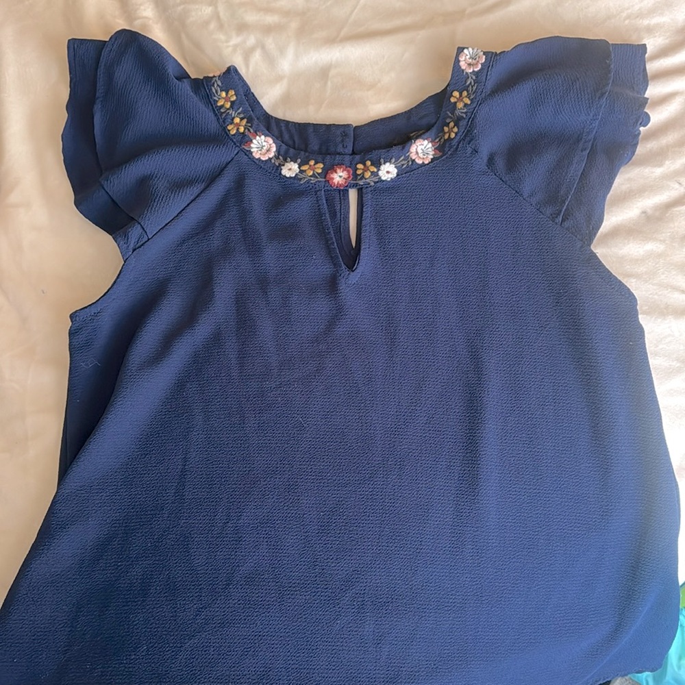 Navy blue top with embroidery collar and keyhole.